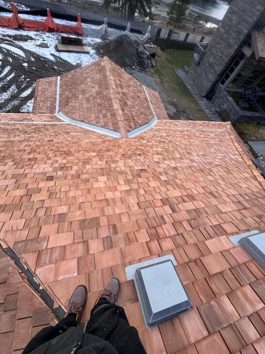 Newly installed cedar shake with galvanized metal valleys 