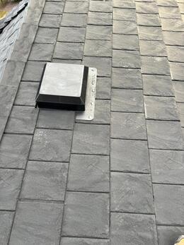 close up view of newly installed Euroshield rubber roofing and a black exhaust vent