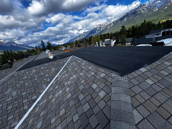 commercial roof restoration and coating in progress calgary ab. Shingle removal from 0/12 roof pitch and replacing with flat EPDM rubber membrane