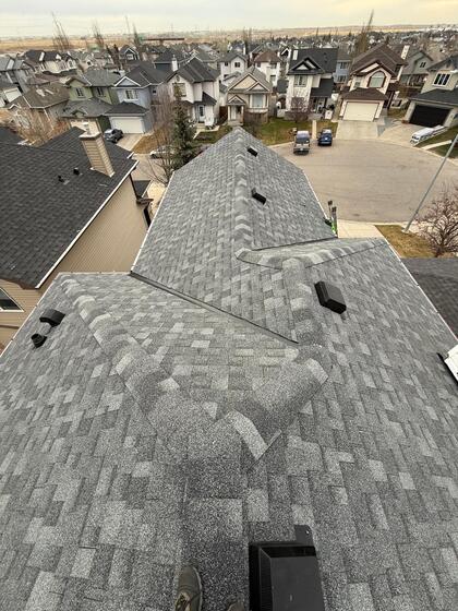 fully completed shingle roof new accessories ridge view