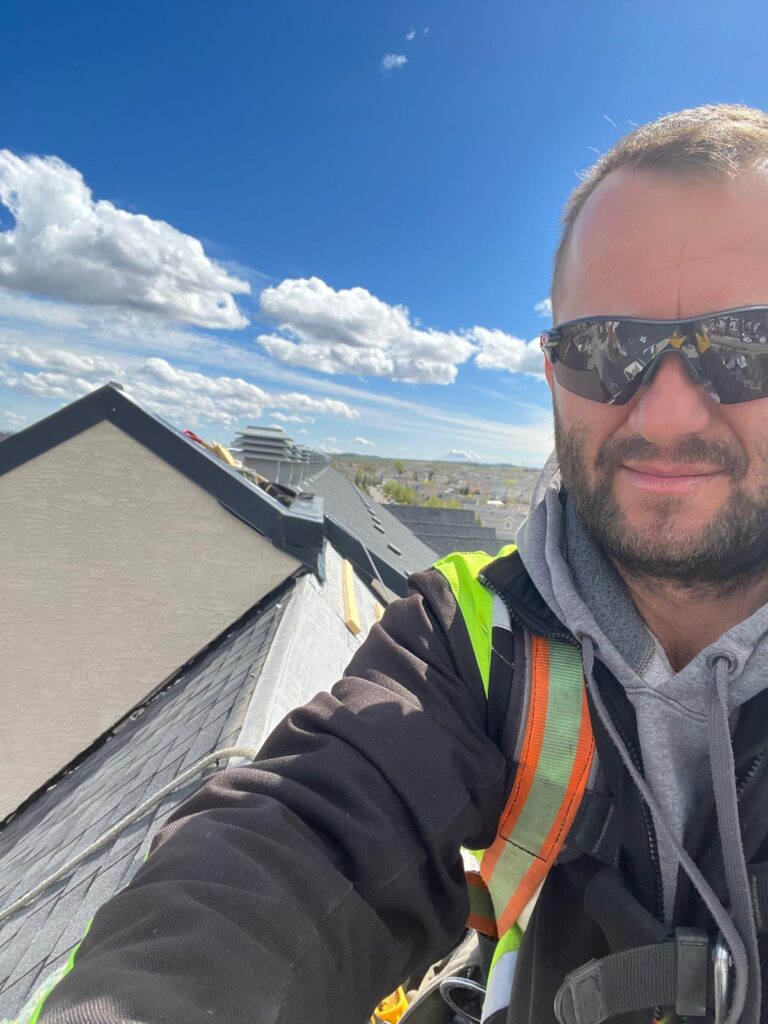 Klodian Hoxha owner of HKS Construction Ltd, on a roof