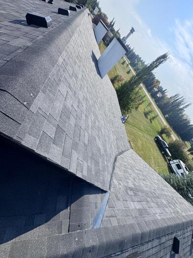 newly installed malarkey shingles on a residential roof in calgary view of two ridge lines