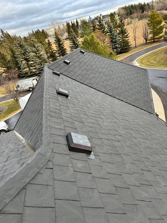 roof ridge view (the roof peak) of installed black euroshield rubber roof combined with black accessories