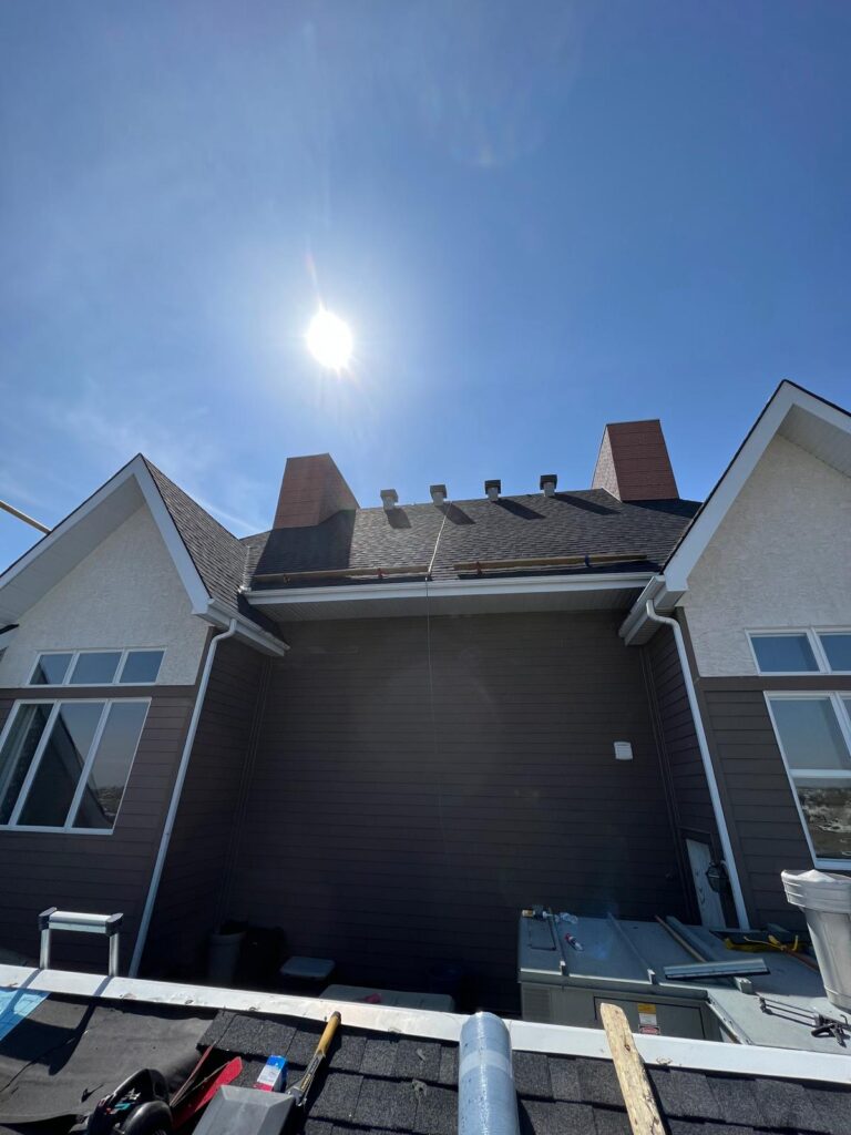 HKS Construction seals every edge — precision parapet flashing on a commercial hail damage re-roof in Calgary