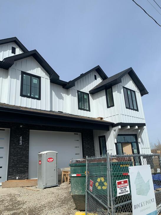 HKS Construction completed white James Hardie board and batten on a contract for Rocky Homes